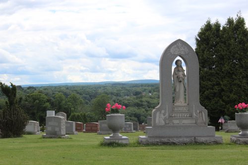 Gallucci family grave marker with a Madonna statue overlooking a valley